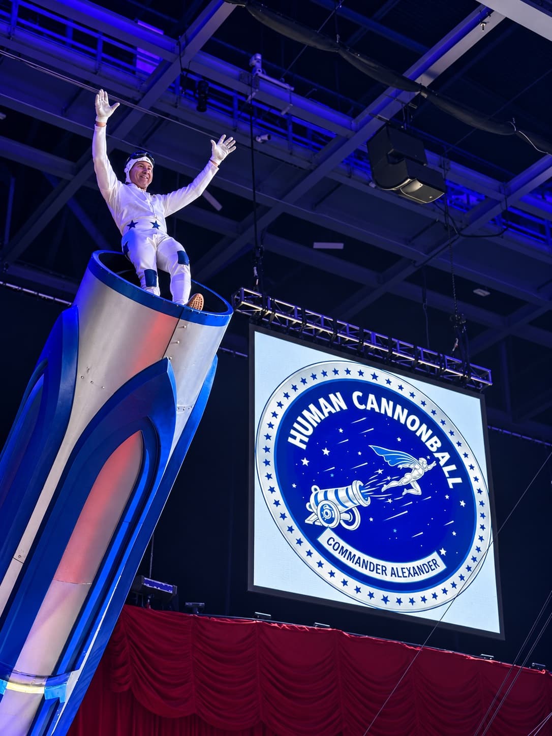 Commander Alexander, the Human Cannonball, waving from the mouth of the cannon